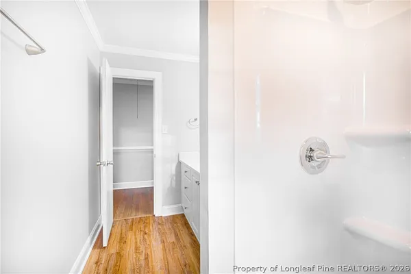 a view of a hallway with wooden floor