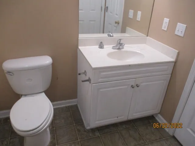 a bathroom with a sink toilet and a mirror