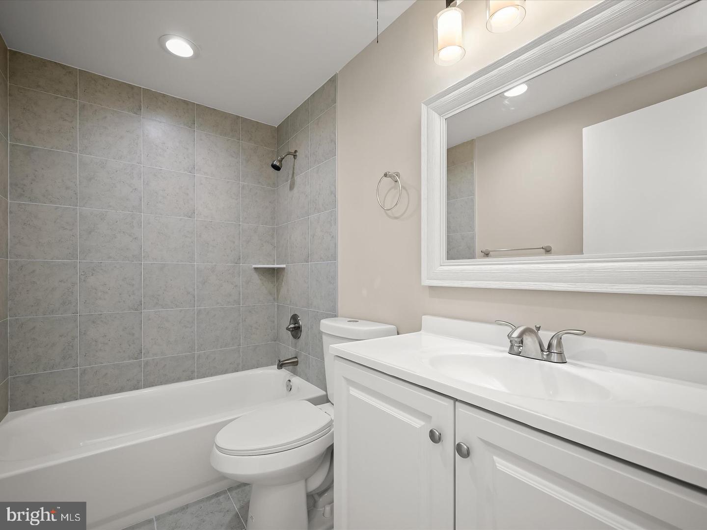 9701 Fields Road, Unit 1607 Gaithersburg, MD 20878 - Photo 12 of 26 a bathroom with a sink a toilet and shower