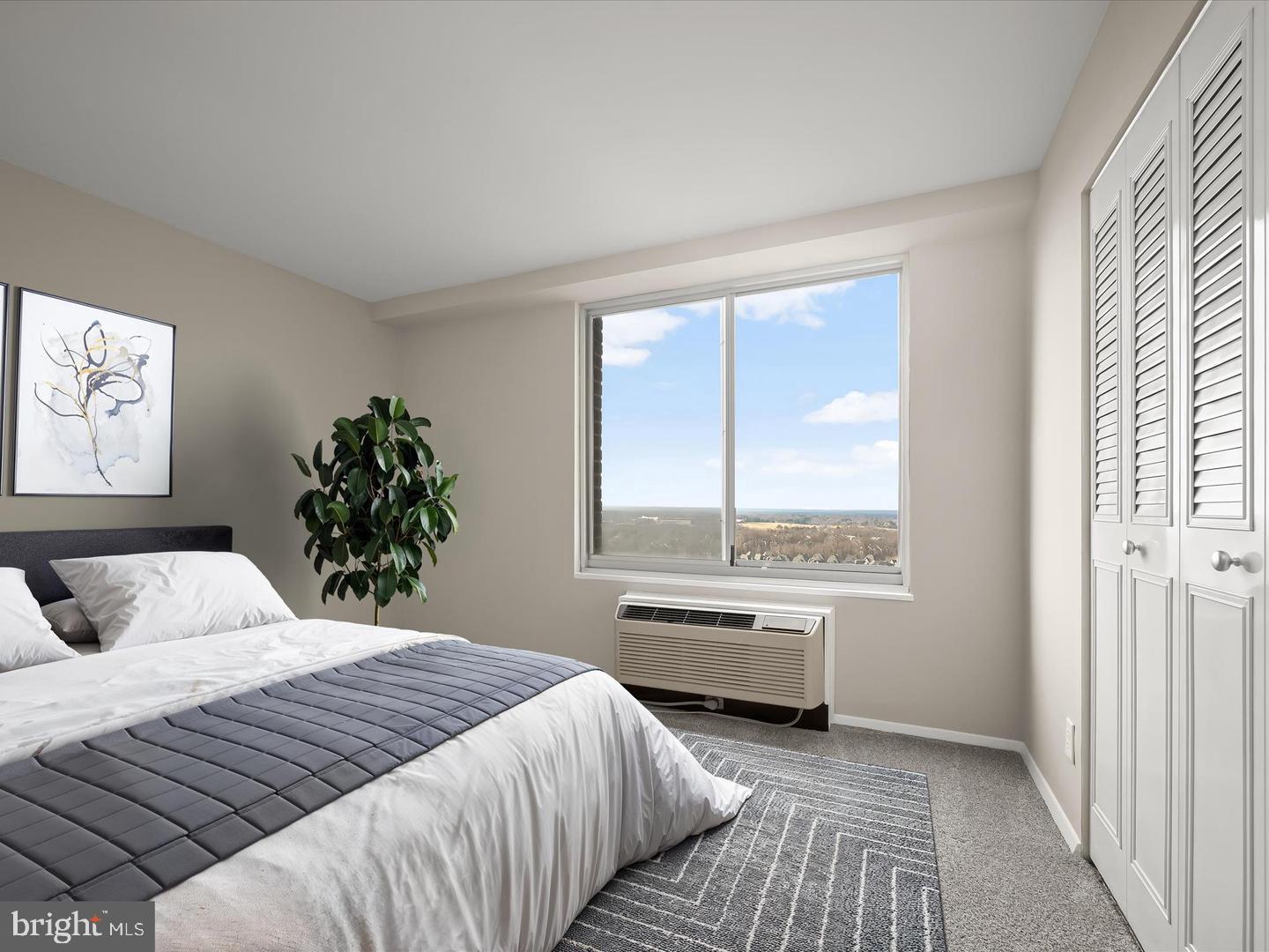 9701 Fields Road, Unit 1607 Gaithersburg, MD 20878 - Photo 17 of 26 a bedroom with a large bed and a large window