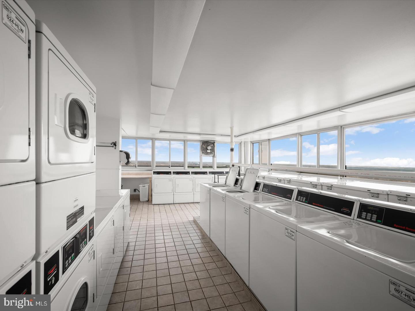 9701 Fields Road, Unit 1607 Gaithersburg, MD 20878 - Photo 20 of 26 a kitchen with stainless steel appliances a white refrigerator a sink a stove and white cabinets