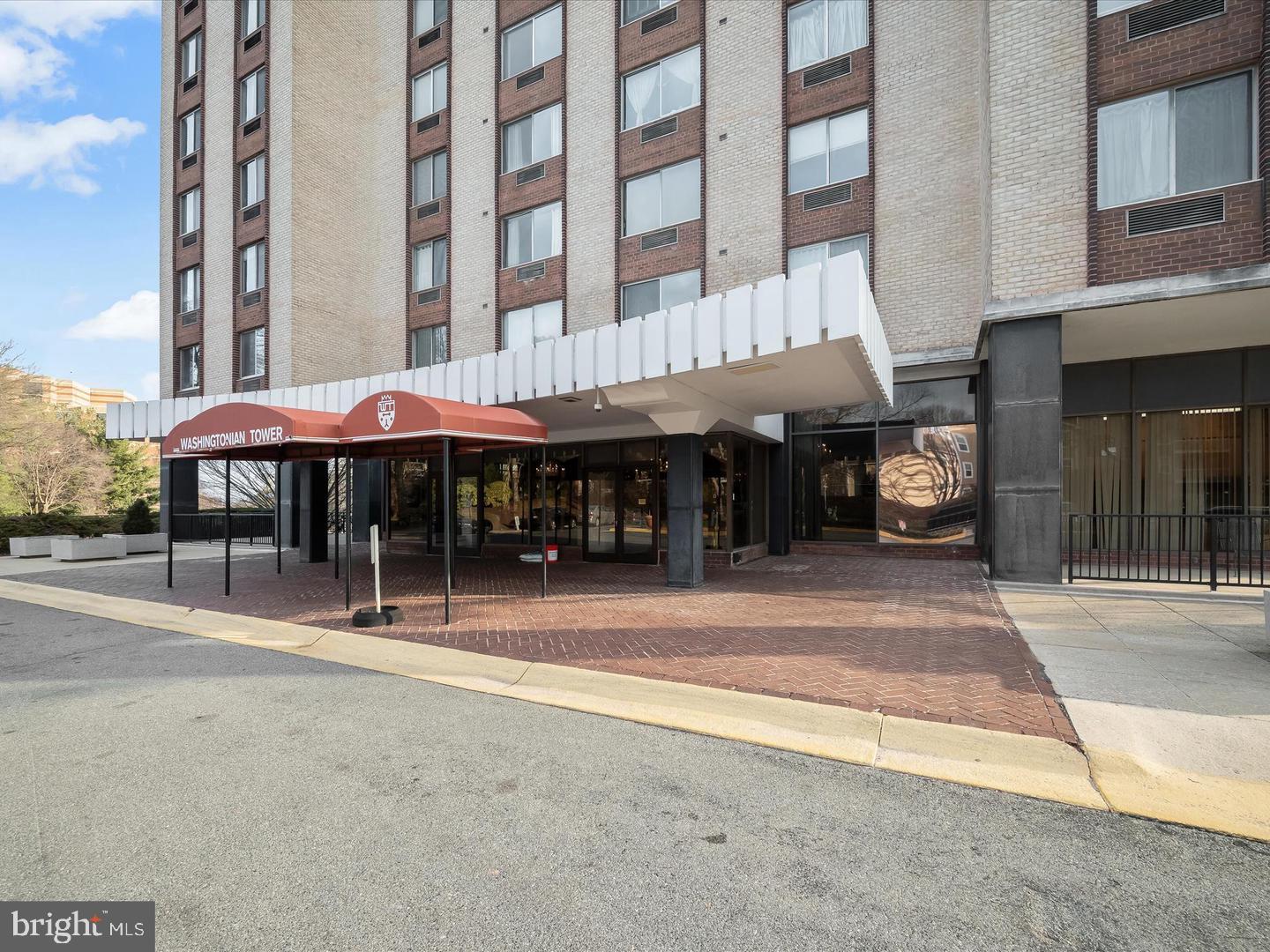 9701 Fields Road, Unit 1607 Gaithersburg, MD 20878 - Photo 2 of 26 a man walking down a street next to a building