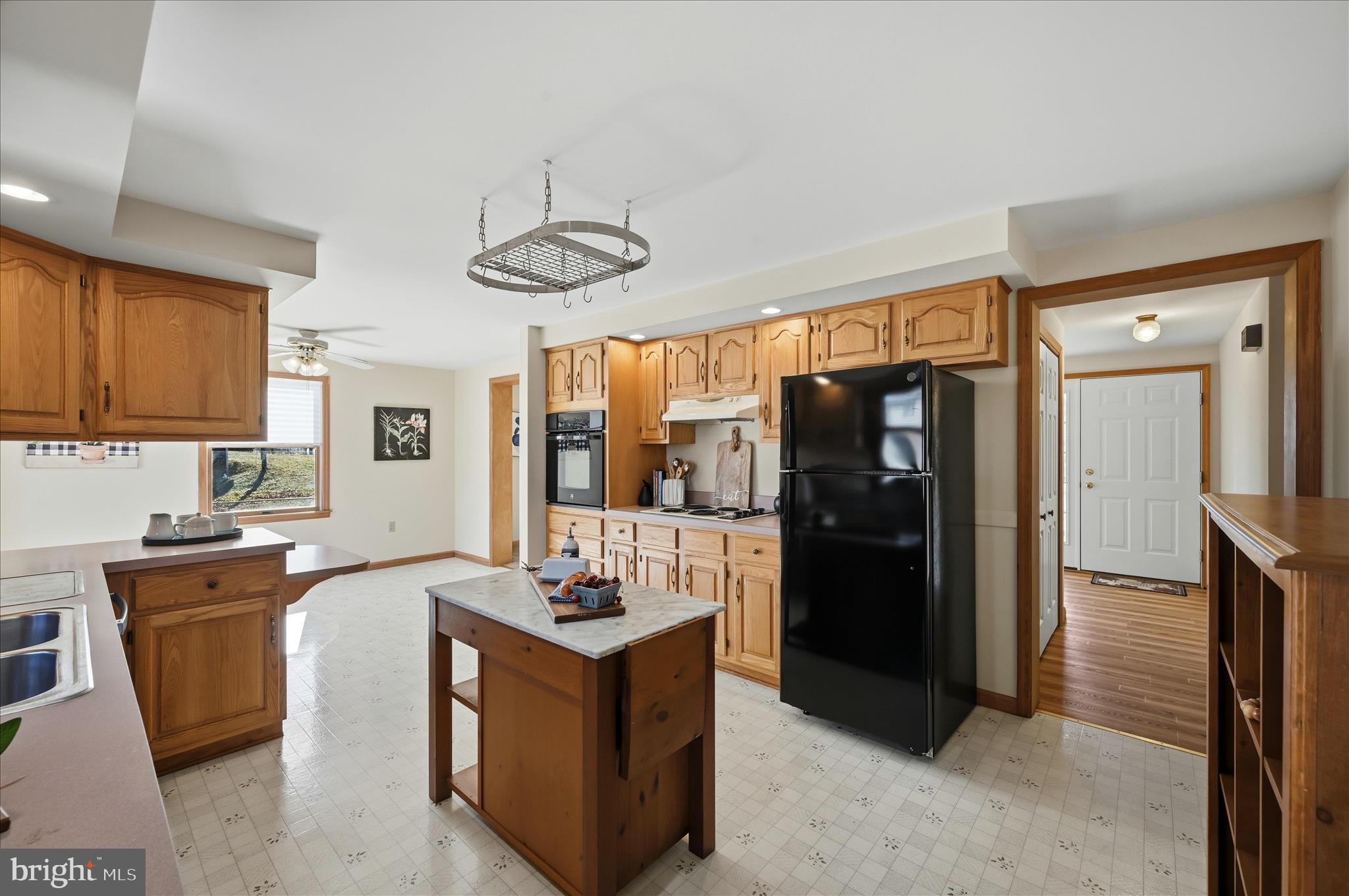 804 North Reymann Street Ranson, WV 25438 - Photo 22 of 53 a kitchen with stainless steel appliances granite countertop a refrigerator a sink dishwasher a stove and a dining table with wooden floor
