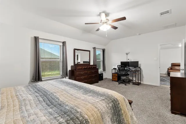 a bedroom with bed and a chandelier