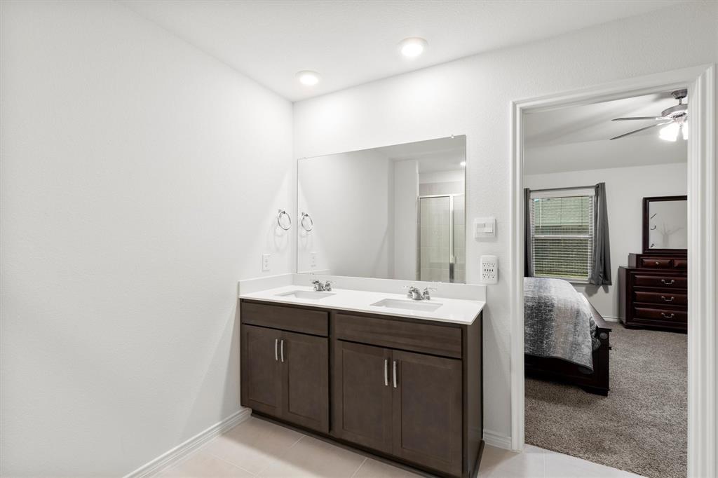 1302 Colonial Bluff Lane Princeton, TX 75407 - Photo 14 of 35 a en suite bathroom with a double vanity sink and a large mirror