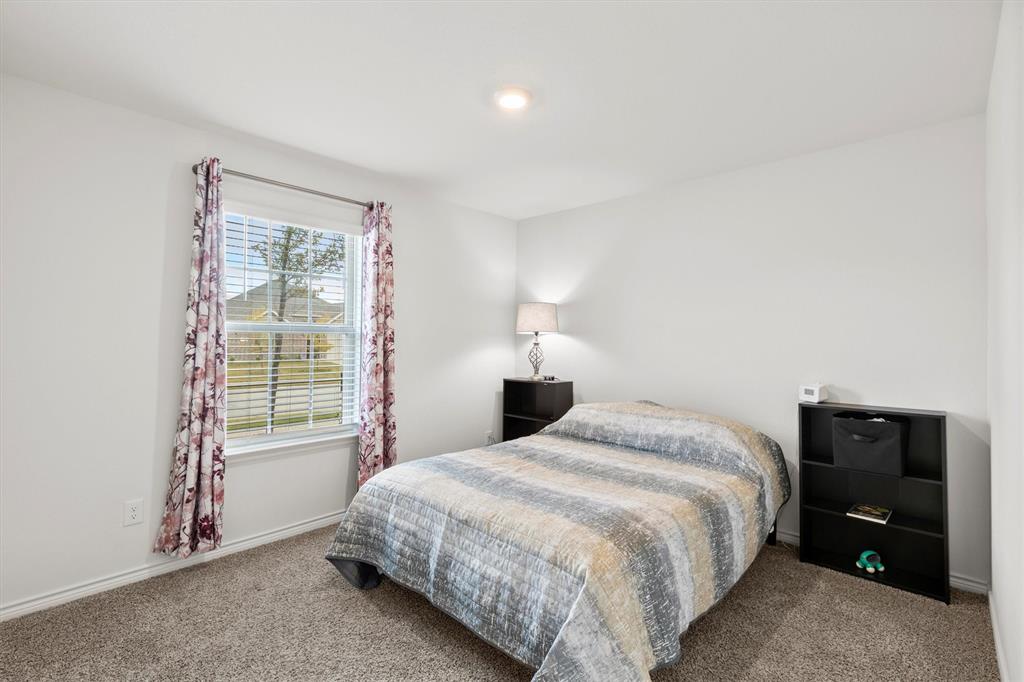 1302 Colonial Bluff Lane Princeton, TX 75407 - Photo 15 of 35 a bedroom with a bed and a window