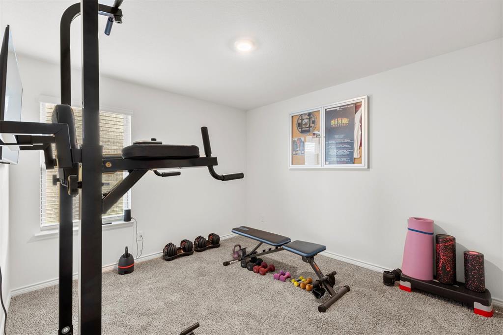 1302 Colonial Bluff Lane Princeton, TX 75407 - Photo 20 of 35 a room with gym equipment and a window