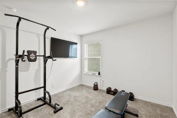 a room with gym equipment and windows