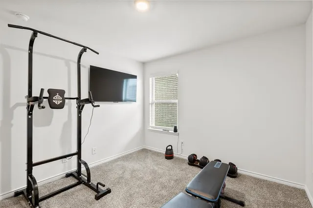 a room with gym equipment and windows