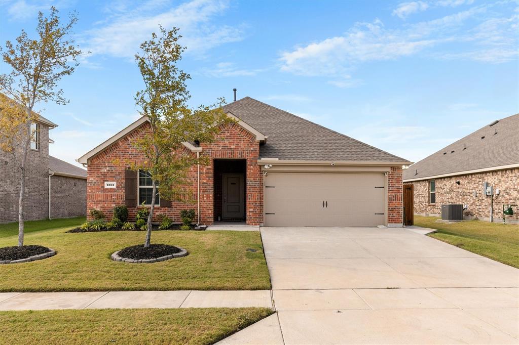 1302 Colonial Bluff Lane Princeton, TX 75407 - Photo 26 of 35 a front view of a house with garden