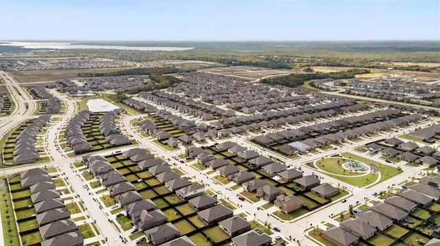 an aerial view of residential building and ocean