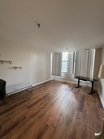 780 South Federal Street, Unit 606 Chicago, IL 60605 - Photo 4 of 11 a view of an empty room with wooden floor and a window