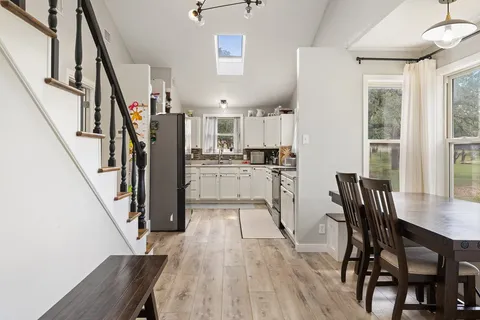 a view of kitchen and dining room with wooden floor
