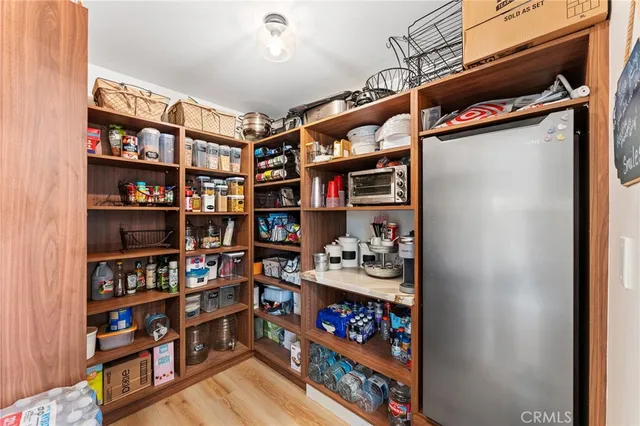 a bedroom with a bed a rug and a large window