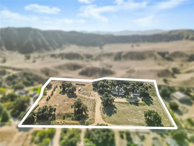 a front view of a house with a yard garden and seating space