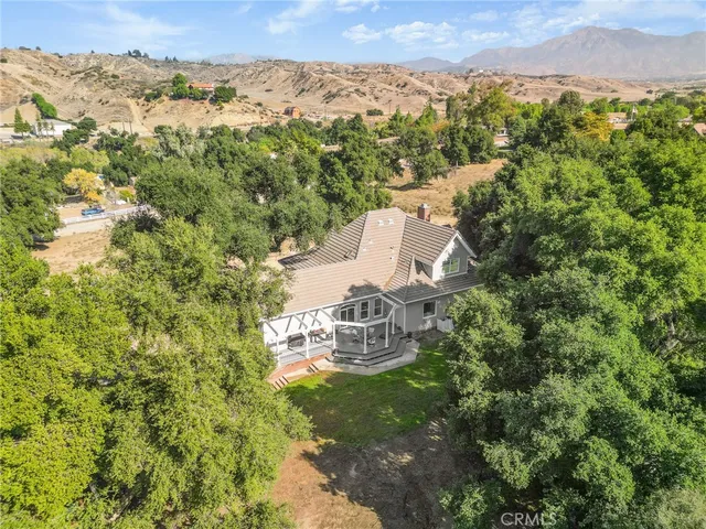 a view of a house with backyard porch and sitting area