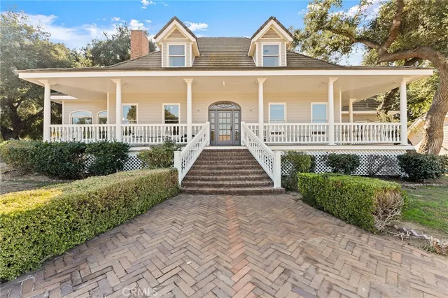 a view of a hallway with wooden floor and stairs