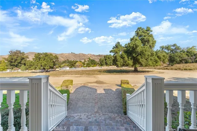 a large kitchen with kitchen island a stove a sink a center island and couches