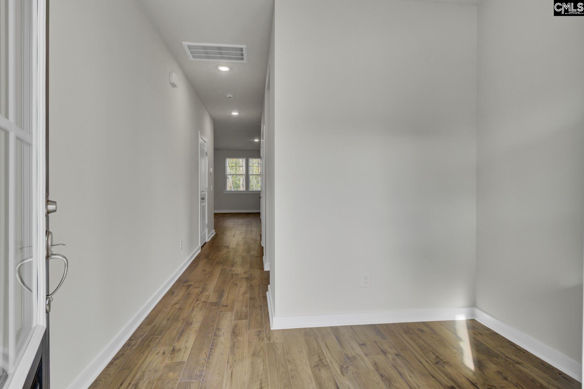 320 Brass Billion Path Lexington, SC 29073 - Photo 4 of 39 a view of a hallway with wooden floor