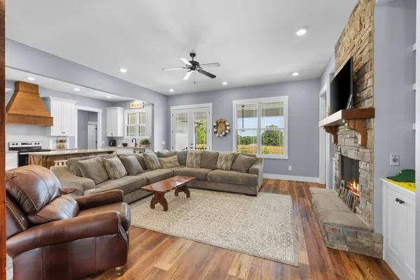 a living room with furniture fireplace and a window