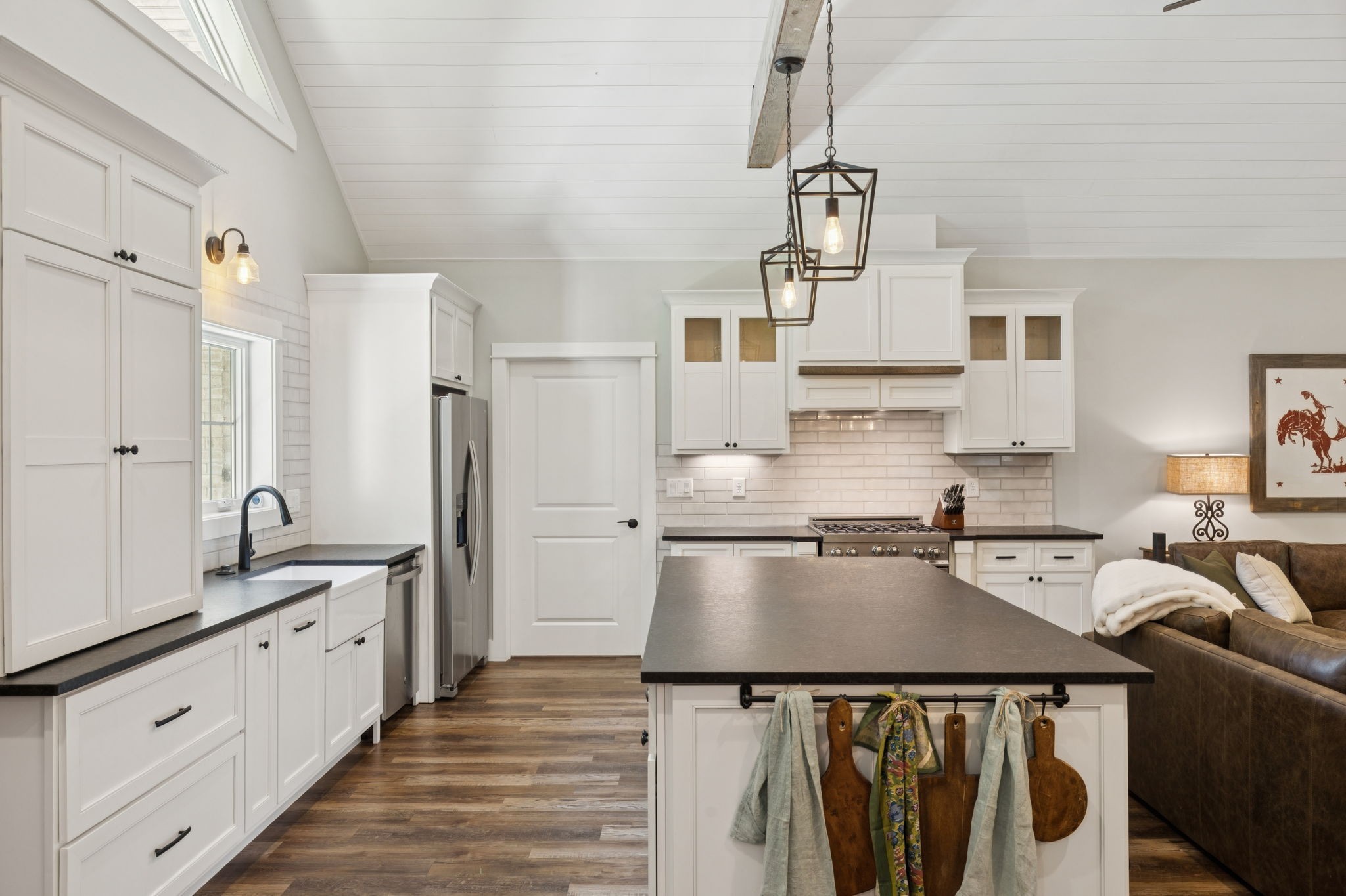 7903 Daugherty-Capley Road Primm Springs, TN 38476 - Photo 25 of 92 a kitchen with stainless steel appliances a stove a sink dishwasher a refrigerator white cabinets and wooden floor