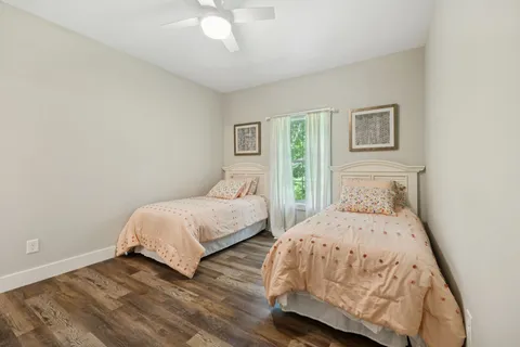 a view of a lush green forest with trees and some houses