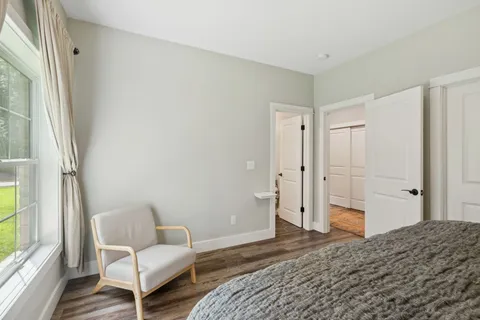 a view of a lush green forest with trees and some houses