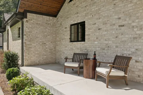 a living room with furniture large window and fireplace