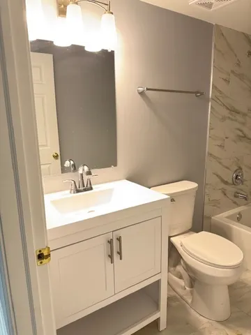 an empty room with wooden floor and window