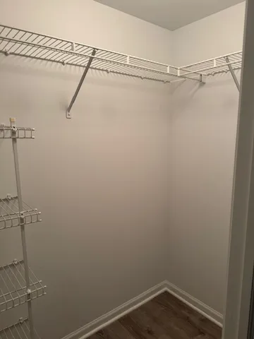 a view of a walk in closet and a bathroom