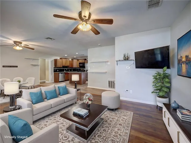 a kitchen with stainless steel appliances kitchen island granite countertop a stove cabinets and wooden floor