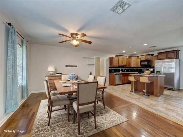 a view of a dining room with furniture and wooden floor