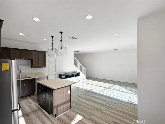 a kitchen with a sink stainless steel appliances and cabinets