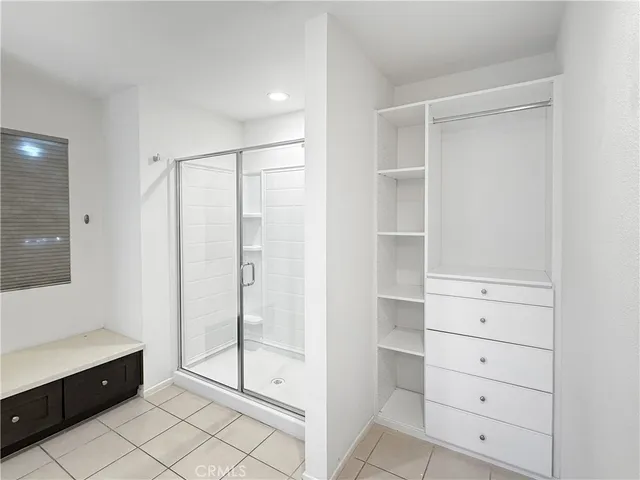 a bathroom with a shower and a sink