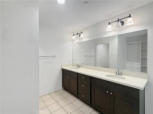 a bathroom with a double vanity sink and mirror