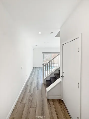 a view of hallway with wooden floor
