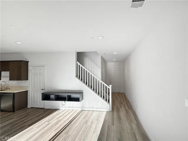 a view of entryway and hall with wooden floor