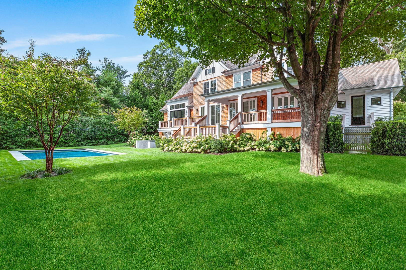 8 Greenway Drive East Hampton, NY 11937 - Photo 34 of 38 a front view of a house with a garden