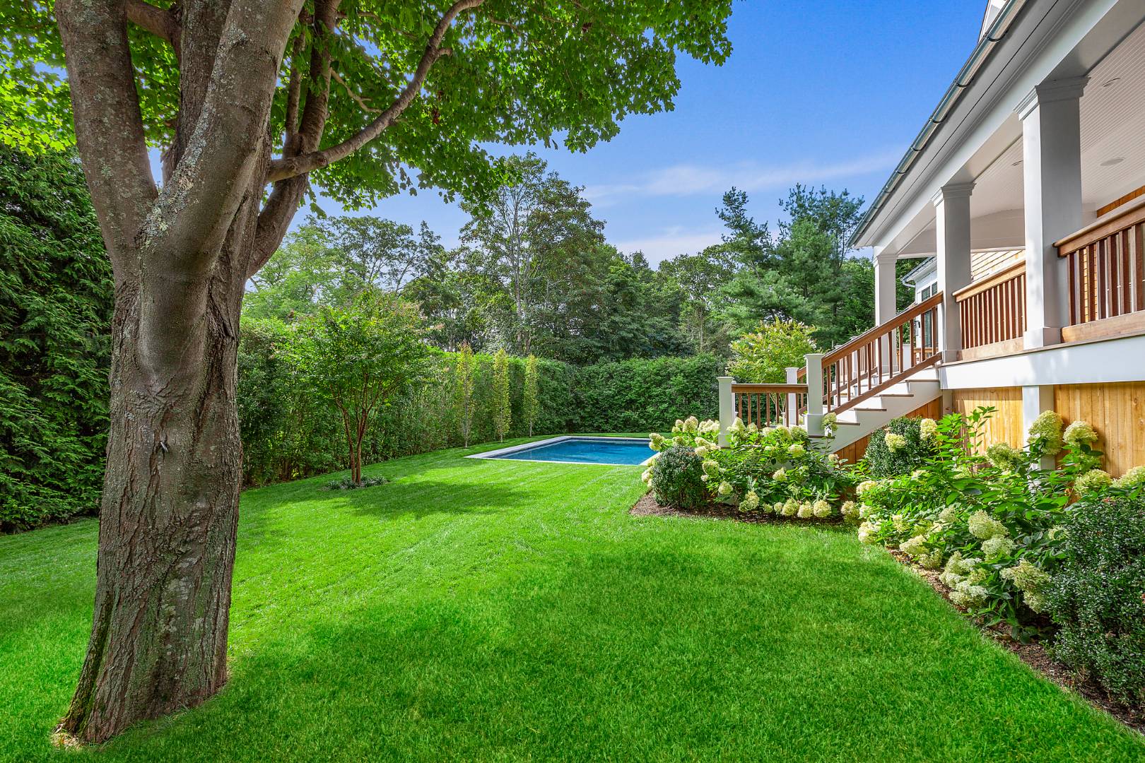 8 Greenway Drive East Hampton, NY 11937 - Photo 36 of 38 a view of a garden with a building in the background