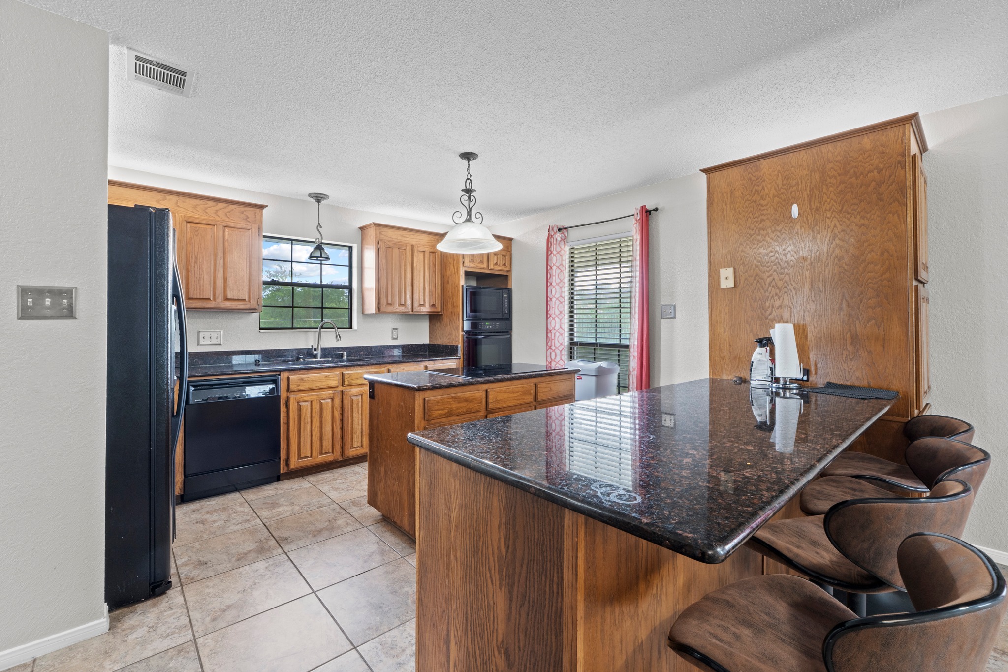 205 Sedro Trail Georgetown, TX 78633 - Photo 16 of 32 An inviting kitchen with a central island and a breakfast bar, perfect for casual dining and entertaining.