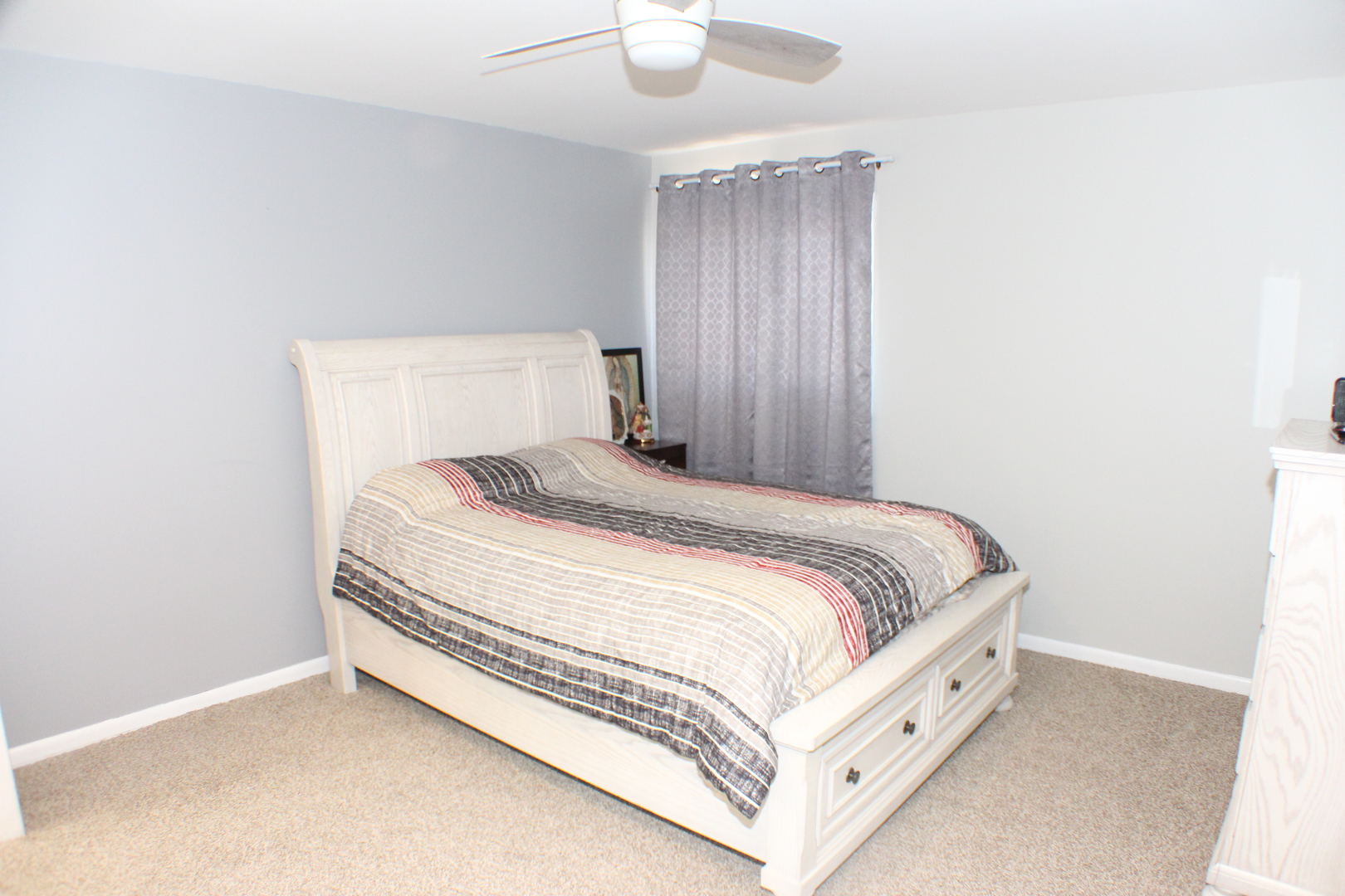 5113 44th Avenue Moline, IL 61265 - Photo 15 of 30 a bed sitting in a spacious bedroom and a chandelier