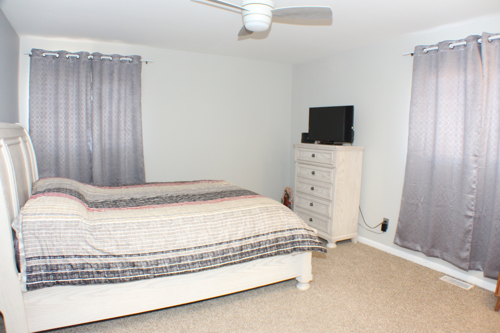 5113 44th Avenue Moline, IL 61265 - Photo 16 of 30 a bedroom with a bed and a flat screen tv