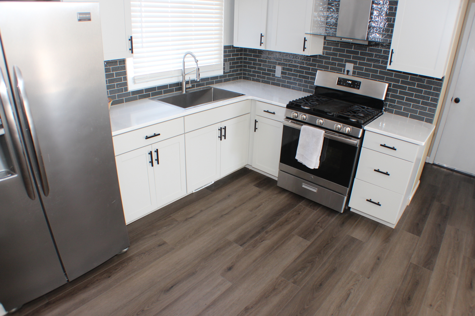 5113 44th Avenue Moline, IL 61265 - Photo 7 of 30 a kitchen with granite countertop a stove and a sink