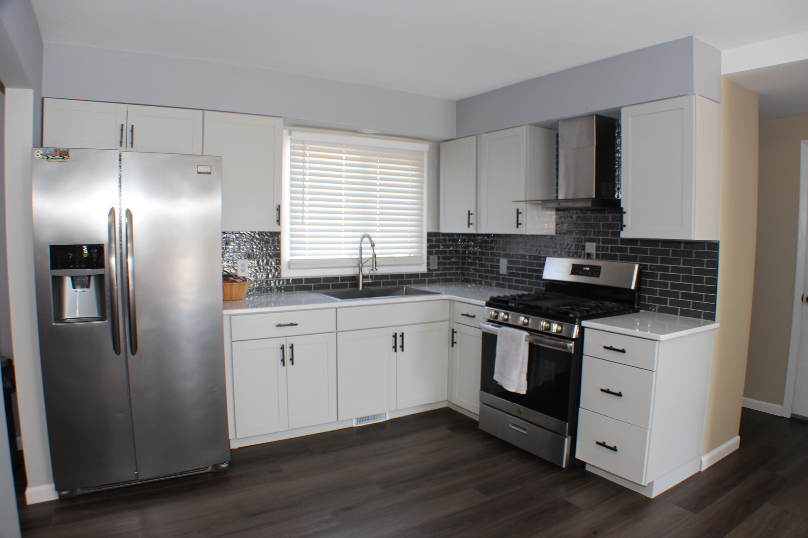 5113 44th Avenue Moline, IL 61265 - Photo 9 of 30 a kitchen with stainless steel appliances granite countertop a stove a sink and a refrigerator