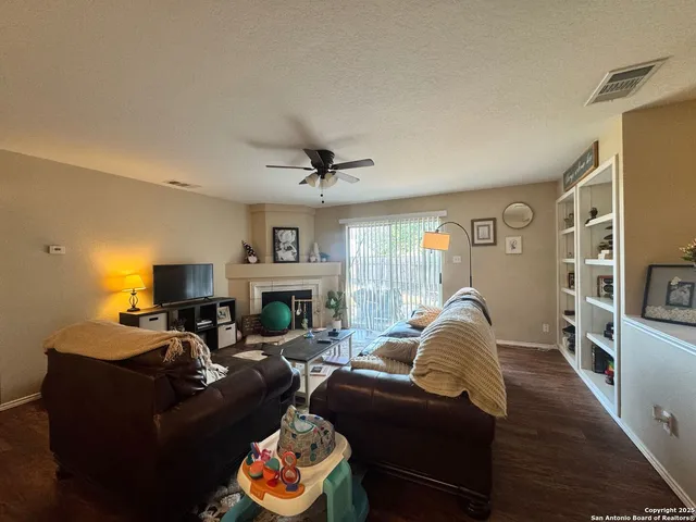 a living room with furniture a fireplace and a flat screen tv