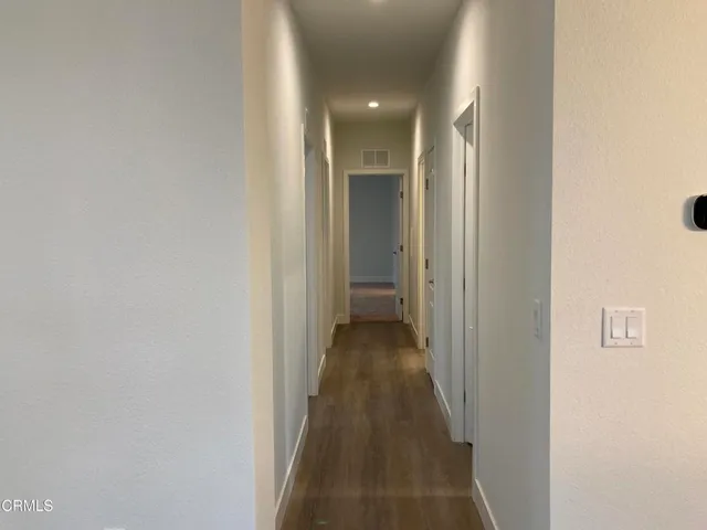 a kitchen with a white cabinets and a refrigerator