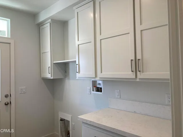 a kitchen with a white cabinets and a sink