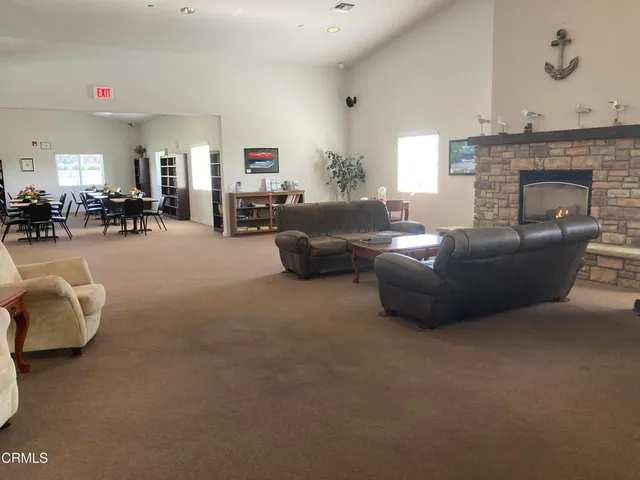 a view of a dining room with furniture and a bookshelf