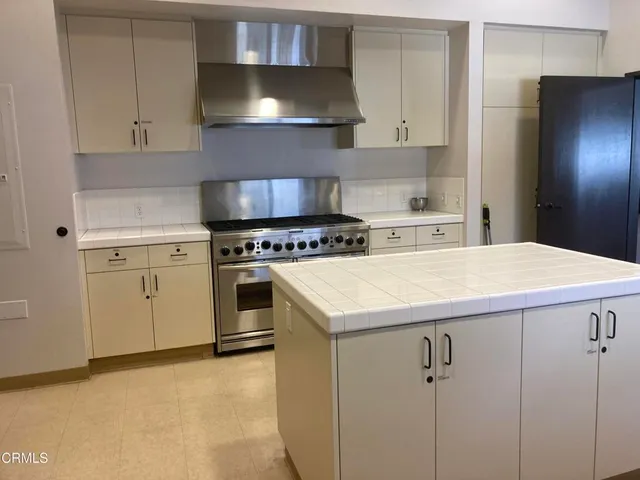 a kitchen with a sink a stove and cabinets