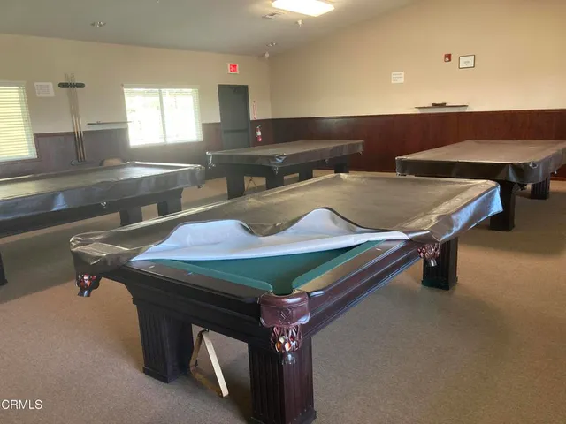 a front view of a house with a garden and outdoor seating